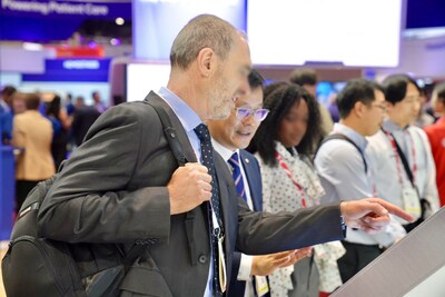 ［照片二］在芝加哥的ADLM 2025，一名與會者在Seegene展覽攤位聆聽有關STAgora™的簡報。