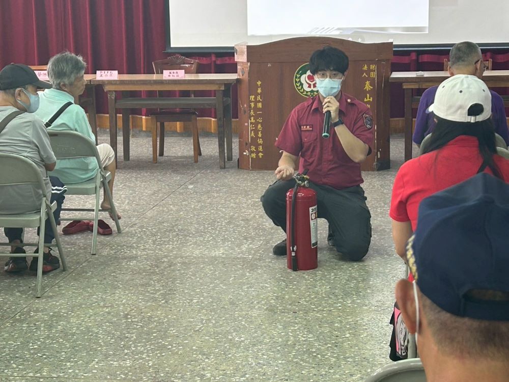 《圖說》消防員於現場示範正確的滅火器使用步驟。〈民政局提供〉